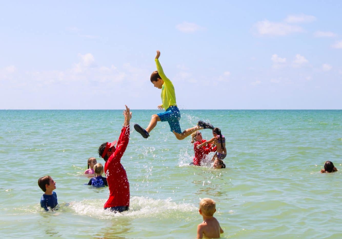 kids having fun in ocean with counselors during Sanibel Sea School summer camp